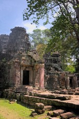 Fototapeta na wymiar Facade and main entrance to the ruins of Ta Prohm temple, located in Angkor Wat complex near Siem Reap, Cambodia.