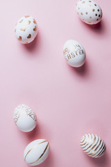 Easter eggs are hand-drawn on pink pastel background. Top view. Flat lay. Space for text. Minimalism and Happy Easter concept.