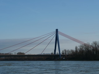 elegant suspension bridge across river against clear sky