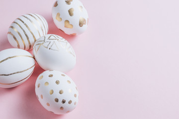 Easter eggs are hand-drawn on pink pastel background. Selective focus. Space for text. Minimalism and Happy Easter concept.