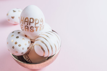 Easter eggs are hand-drawn on pink pastel background. Selective focus. Space for text. Minimalism and Happy Easter concept.