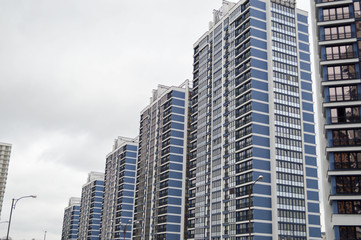 New modern tall blue glass multi-storey comfortable urban monolithic frame houses buildings skyscrapers new buildings in the big city of the megalopolis