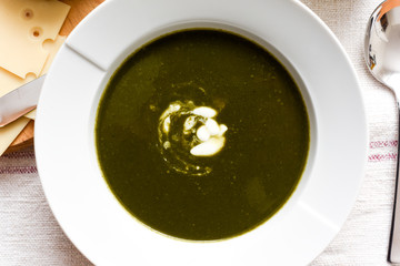 Bowl of spinach soup with a swirl of cream healthy food starter or main meal