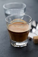 Coffee with milk on dark stone background. Close up.