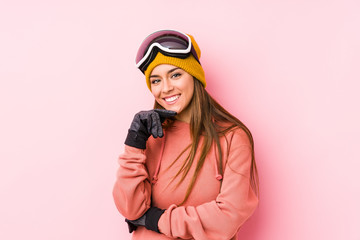 Young caucasian woman wearing a ski clothes isolated smiling happy and confident, touching chin with hand.