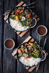 Chinese cuisine.  chinese beef in spicy sauce with rice and  vegetables.  Colorful stir fry in a wok.