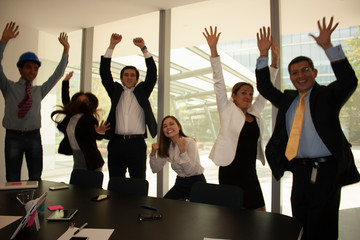 Co-workers in the office jumping for happiness because they have managed to close a contract in Mexico City