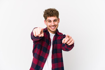 Fototapeta premium Young blond curly hair caucasian man isolated cheerful smiles pointing to front.