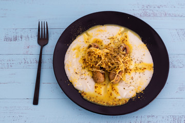 vegan version of bangers and mash potato with veggie sausages topped with sauerkraut