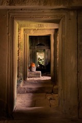 Fototapeta na wymiar Interior doorway at Ta Prohm temple ruins, located in Angkor Wat complex near Siem Reap, Cambodia.