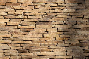 Texture of a stone wall in sunlight