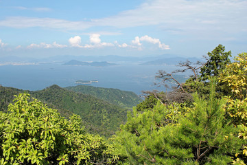 Obraz premium Miyajima, Japan - July 20, 2019: A far side of Hiroshima Bay as seen from the top of Misen mountain, Miyajima