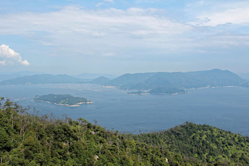 Fototapeta na wymiar Miyajima, Japan - July 20, 2019: A far side of Hiroshima Bay as seen from the top of Misen mountain, Miyajima