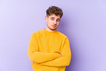 Young blond curly hair caucasian man isolated unhappy looking in camera with sarcastic expression.