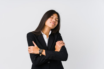 Young asian business woman hugs, smiling carefree and happy.