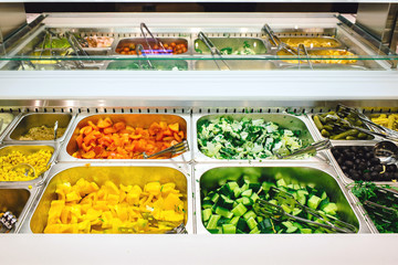 salad bar with assortment fresh ingredients, fruits and proteins. choice of healthy foods for salads. healthy eating concept