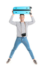 Male tourist with luggage on white background