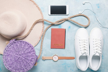 Female clothes, mobile phone, bag and passport on color background. Travel concept