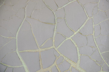 Dried gray paint on the door. Gray background, cracked paint on an old iron door