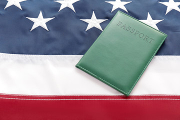 Fototapeta premium Passport on USA flag. Immigration concept