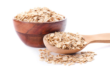 Bowl and spoon with raw oatmeal on white background