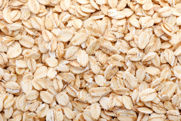 Raw oatmeal as background, closeup