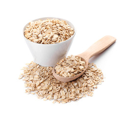 Bowl and spoon with raw oatmeal on white background