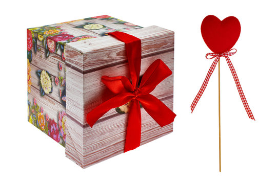 Gift box with scarlet bow, yellow and pink roses. Decorative red hearts. Isolated, white background.