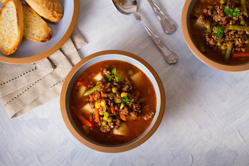 Delicious hamburger soup with vegetables. Healthy nutrition food. View from above, top view
