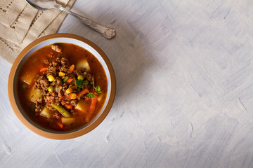 Delicious hamburger soup with vegetables. Healthy nutrition food. View from above, top view