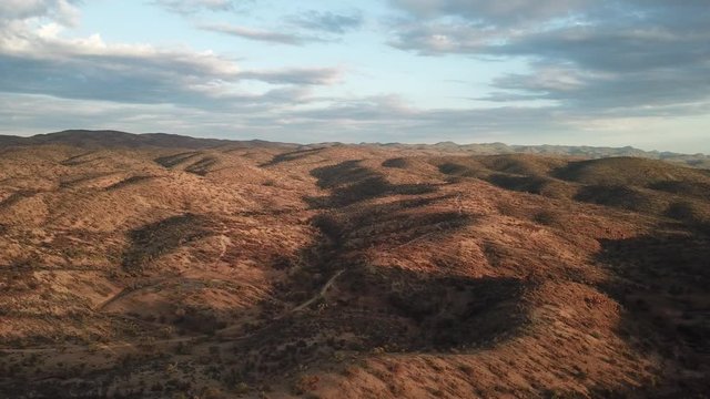 4K aerial drone summer day video African savanna and dry riverbeds surrounded by bush covered hills in Daan Viljoen National Game Park in Khomas Hochland area near Windhoek, Namibia's capital, Africa