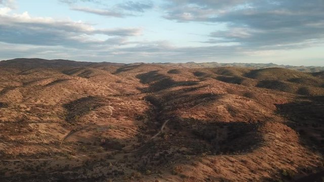4K aerial drone summer day video African savanna and dry riverbeds surrounded by bush covered hills in Daan Viljoen National Game Park in Khomas Hochland area near Windhoek, Namibia's capital, Africa