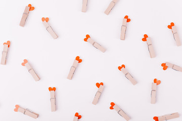 Beautiful greeting card or background design of Pink Hearts pinned with a clothes peg. White background. Copy Space for Texts