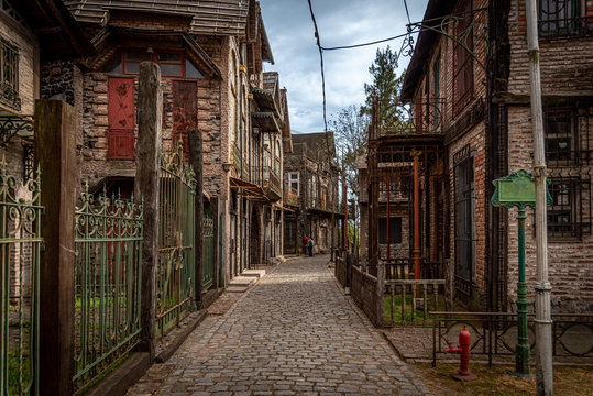 GONZALEZ CATAN, ARGENTINA, SEPTEMBER 28, 2019: People walking along cobblestone path through abandoned buildings in the amazing medieval town of Campanopolis.