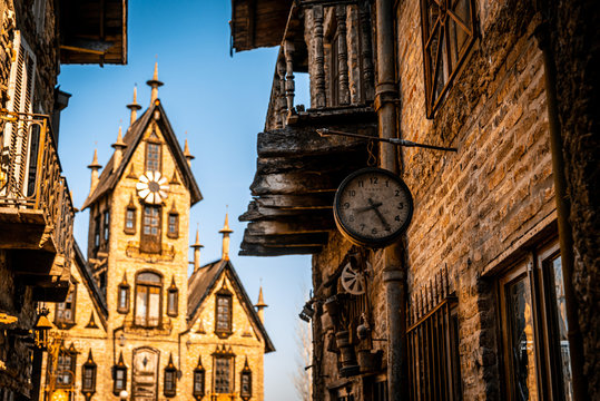 GONZALEZ CATAN, ARGENTINA, SEPTEMBER 28, 2019: Very old watch hanging from a brick wall of abandoned building in the amazing medieval town of Campanopolis.