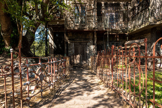 GONZALEZ CATAN, ARGENTINA, SEPTEMBER 28, 2019: entrance path to abandoned building in the amazing medieval town of Campanopolis, with rusty iron fences at both sides on a sunny day.
