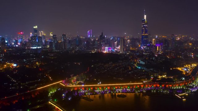 night time illuminated nanjing city wall lakeside downtown district aerial timelapse panorama 4k china
