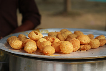 Fusca Chotpoti is Popular street food of Bangladesh and India. this food Looks like chips.a roadside shop Indian bengali food dish and pot.Testy and lucrative food.The dish consists mainly of potatoes