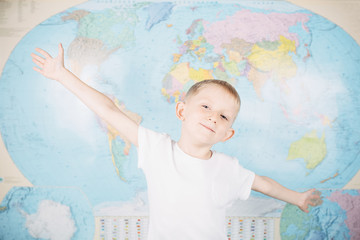 little boy on the background of a world map