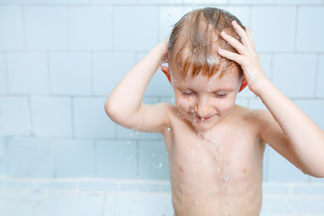 little boy washes in the shower