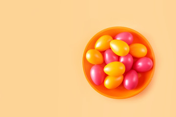 Fototapeta na wymiar Orange and red Easter eggs in a plate