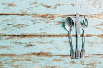 Cutlery on rustic wooden background. Flat lay, top view with copy space