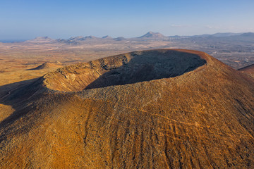 Beautiful panoramic birds eye view on Calderon Hondo, Fuerteventura island. Aerial shooting vulcano...