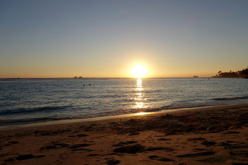 Sunset as wave lap towards the beach from the ocean