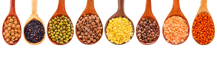 Collection of various lentils in a wooden spoons isolated on a white background. Top view.