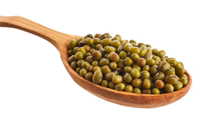 Green lentils in the wooden spoon isolated on a white background. Top view.