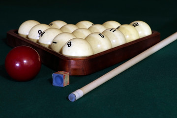 Billiard table with balls, cue, triangle. Green cloth. Playing billiard and pool. Ruusian billiard.