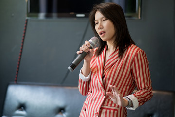 woman holding microphone, girl singing