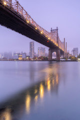 View on Queensboro bridge and Midtown manhattan on a foggy morning from East river with long exposure