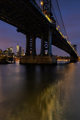 Fototapeta na wymiar View on Manhattan Bridge and Financial District with Brooklyn bridge from East river , long exposure during sunrise
